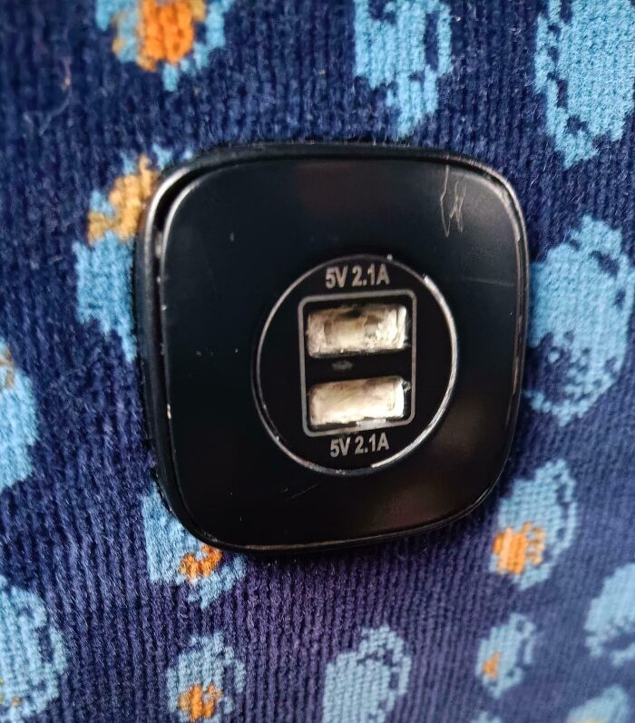 Broken USB ports on a bus seat, portraying people being complete jerks by damaging facilities.