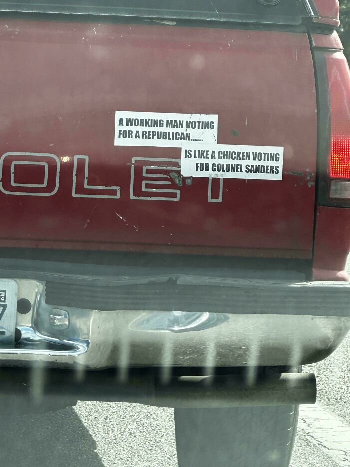 Funny bumper sticker on red truck comparing voting choices to a chicken voting for Colonel Sanders.