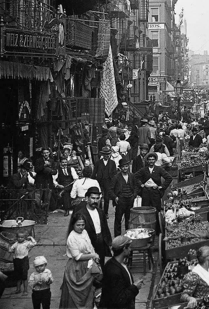 Bustling historical street scene showcasing how people lived decades ago, with a crowded market and vintage attire.