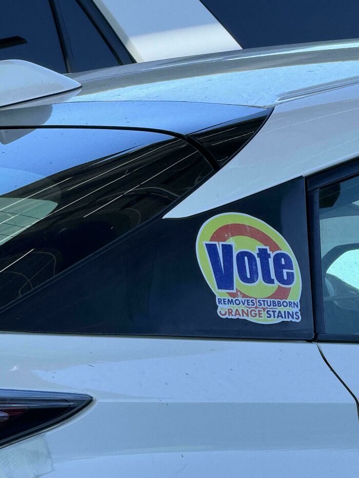 Car with a funny bumper sticker that reads, "Vote removes stubborn orange stains."