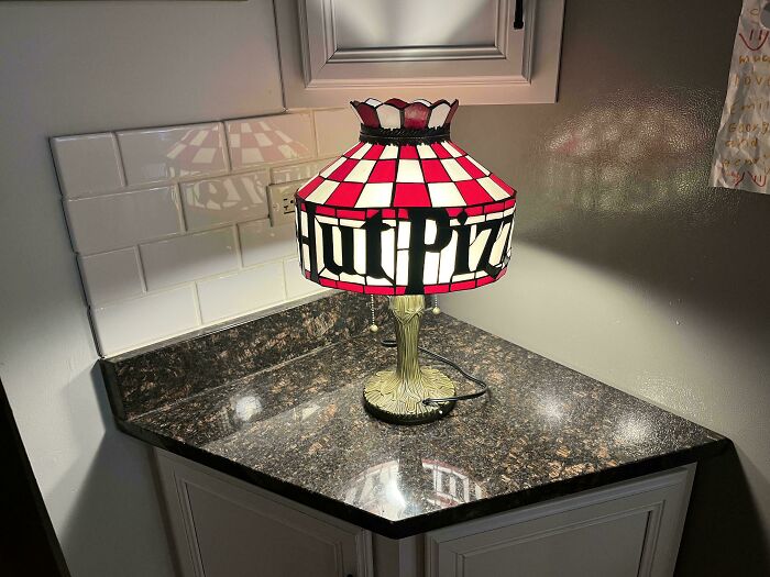 Vintage stained glass lamp with a red and white checkered pattern, featuring "Pizza" text, found while thrifting.