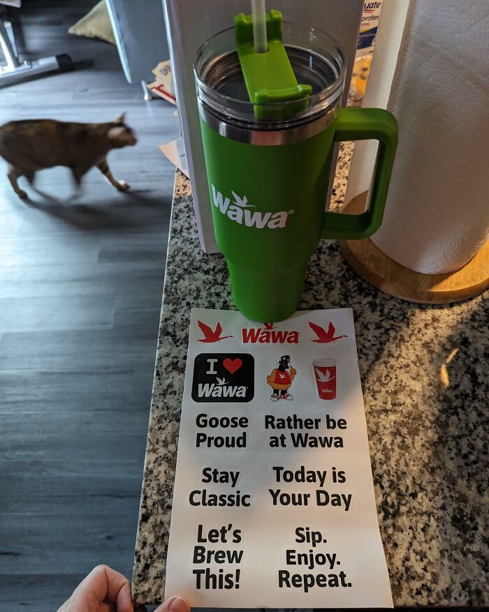 Image of a green Wawa tumbler and branded paper on a countertop, related to company gifts or bonuses.