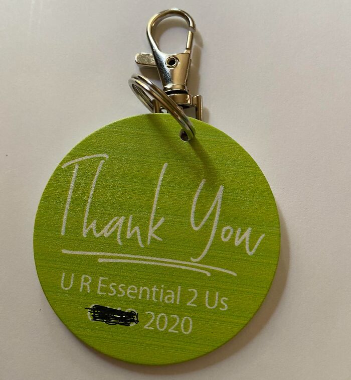 Green keychain with "Thank You" message; an example of infuriating company gifts bonuses.