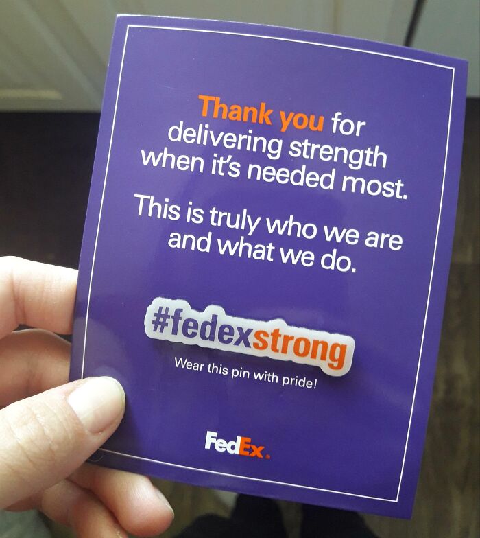A hand holding a #fedexstrong card; example of infuriating company gifts.
