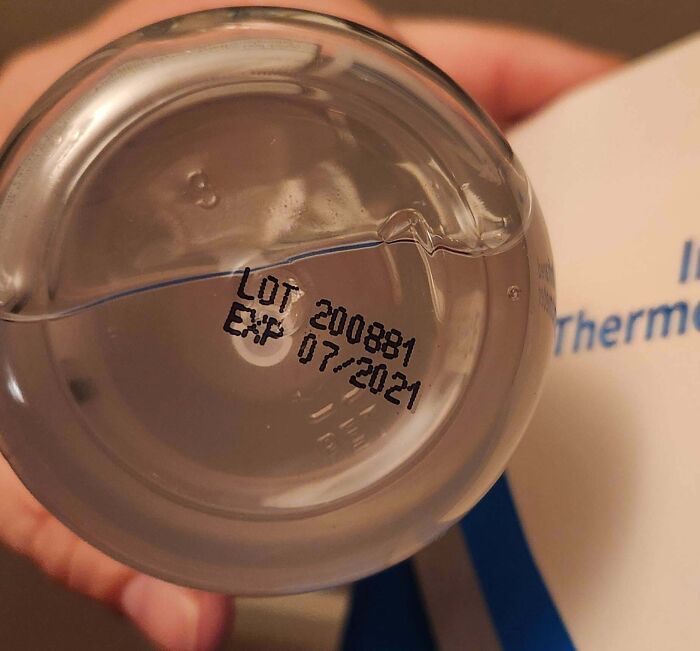 Expired water bottle seen as infuriating company gift, expiration date 07/2021.