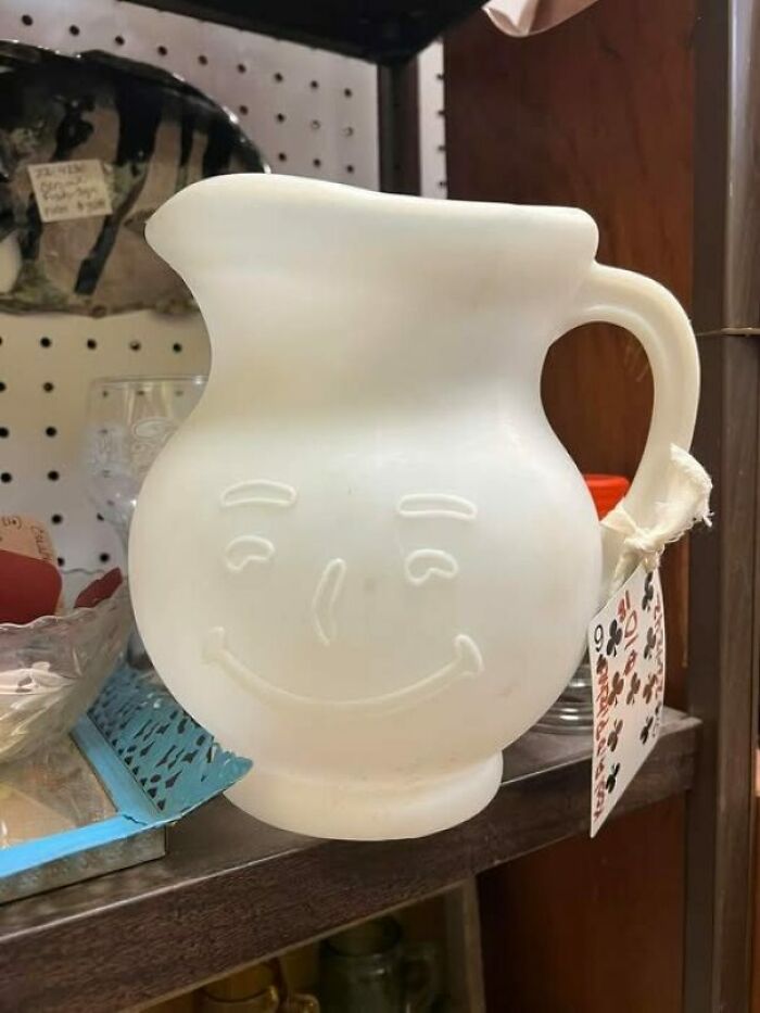 Smiling face pitcher found as a weird secondhand item on a shelf.