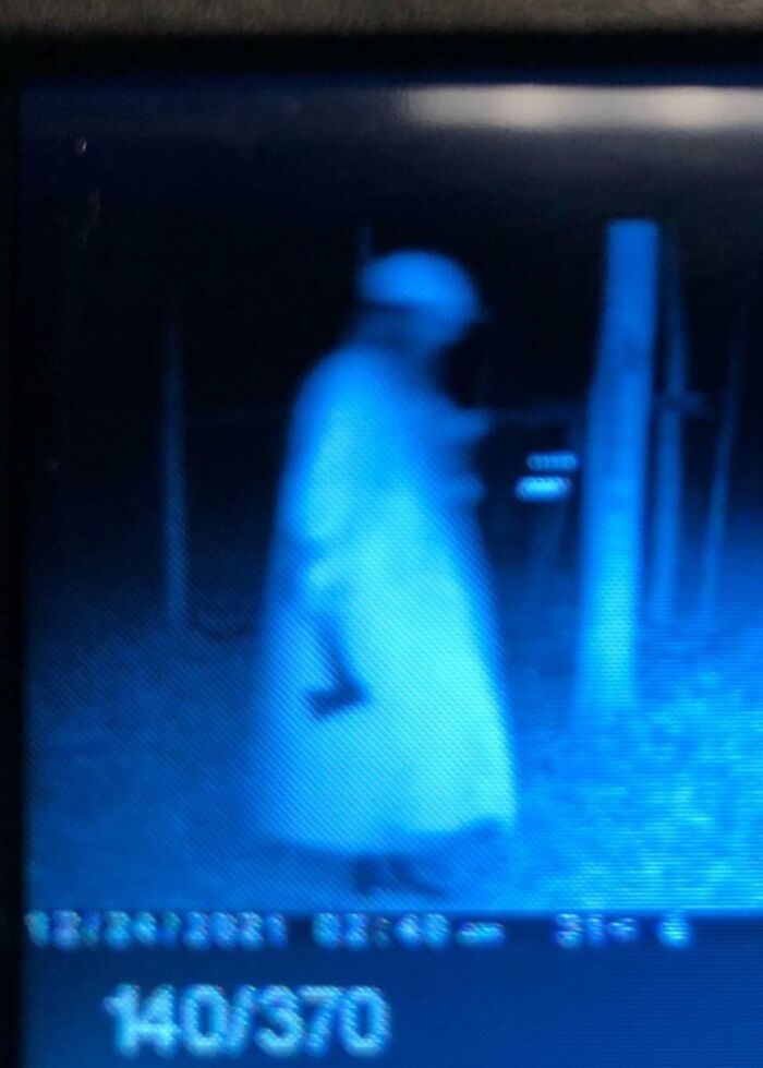 Blurred figure in white robe captured at night, representing creepy trail cam pictures.