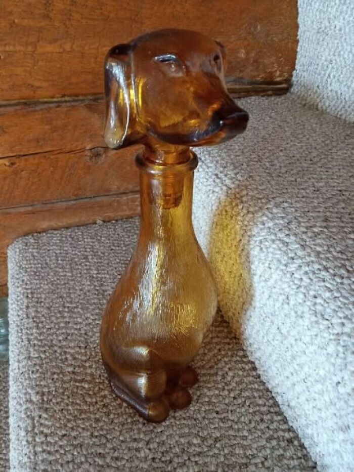 A brown glass bottle shaped like a dog found as a secondhand treasure.