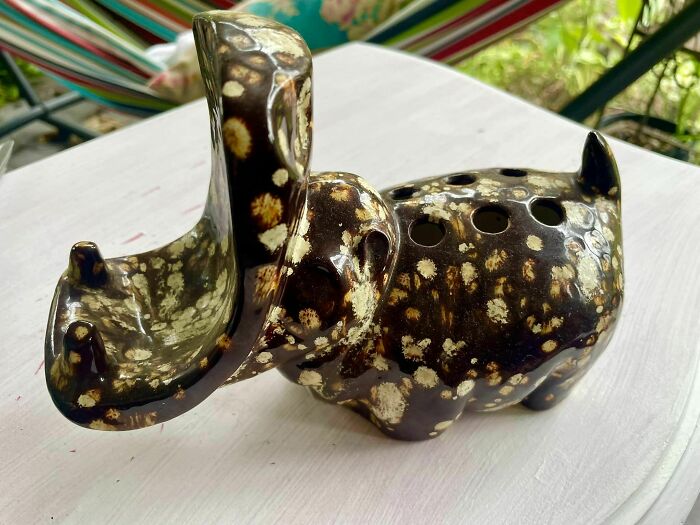Ceramic elephant with unique spots, a quirky secondhand find on display outdoors.
