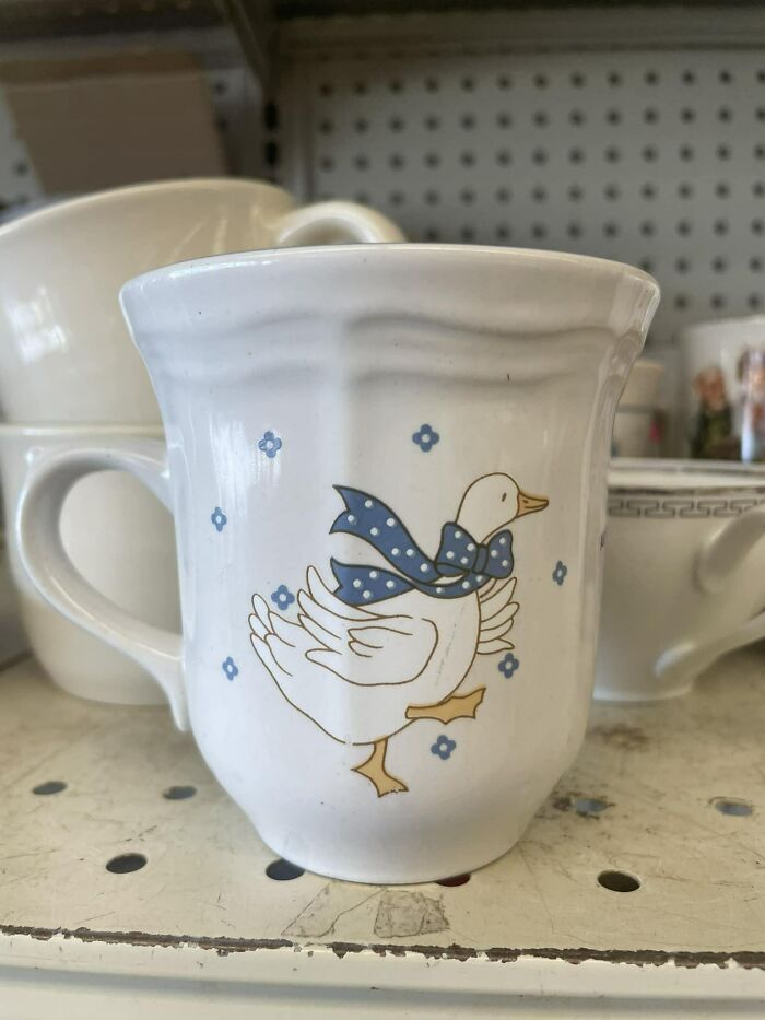 Secondhand find: a ceramic mug with a duck wearing a blue scarf and small blue flowers.