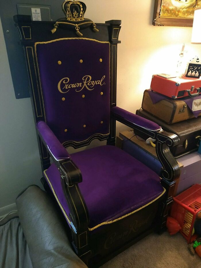Crown Royal throne chair with purple velvet upholstery, a quirky secondhand find in a cozy room setting.