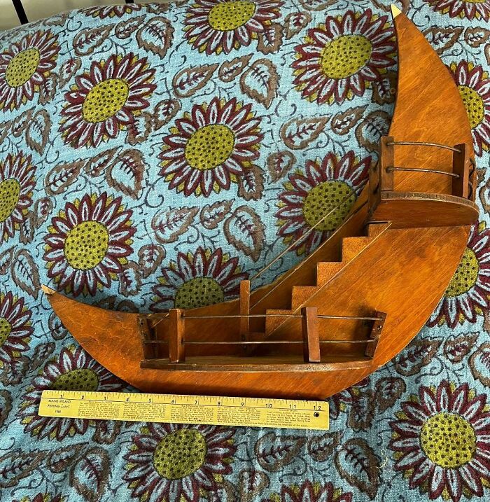 Wooden crescent moon shelf with stairs on floral fabric, featured as a weird and wonderful secondhand find.