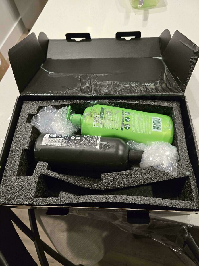 Two large bottles awkwardly packaged in a foam box, highlighting a funny online shopping fail.
