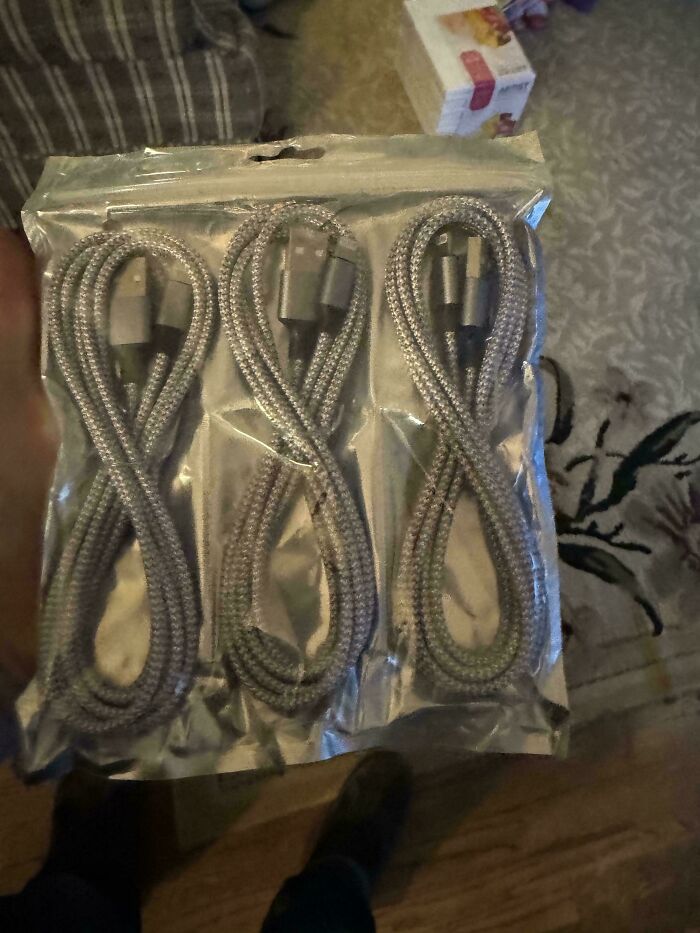 Pack of three charging cables packaged in figure-eight loops, showcasing online shopping fails with misleading presentation.