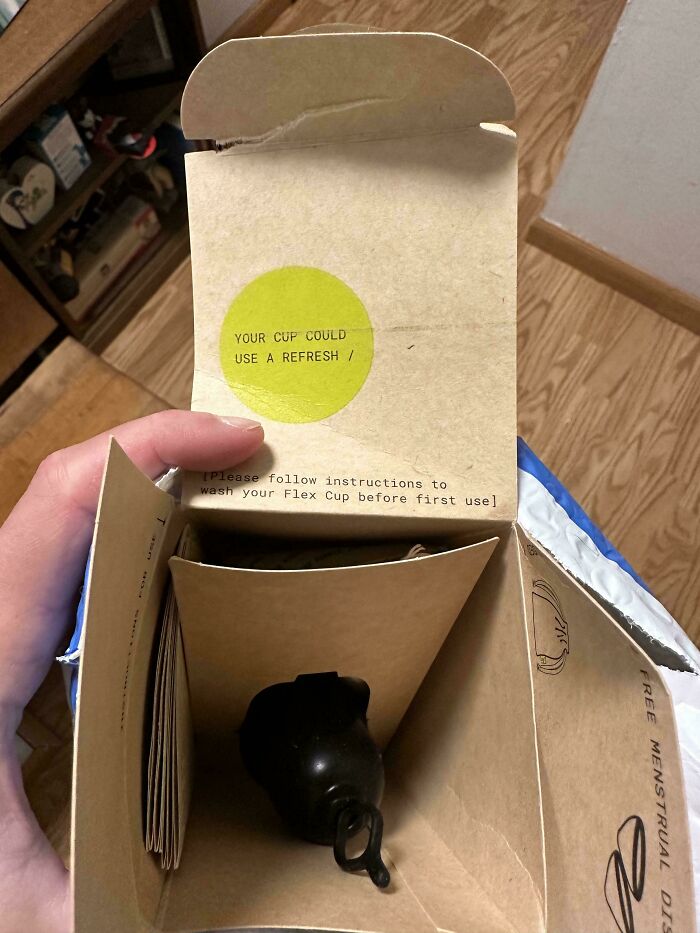 Cardboard box with humorous online shopping fail, showing unexpected product inside.