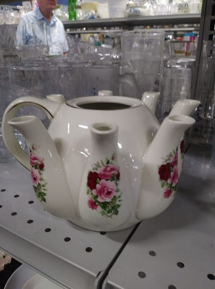 Unique secondhand teapot with multiple spouts and floral pattern found in a thrift store.