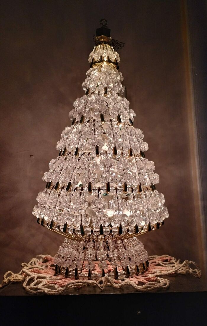 Crystal Christmas tree lamp, a weird and wonderful secondhand find, glowing warmly in a dimly lit room.