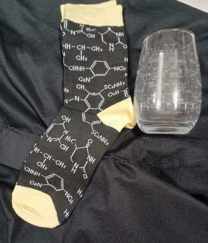 Socks and glass with chemical patterns, representing a company's infuriating gifts bonuses.