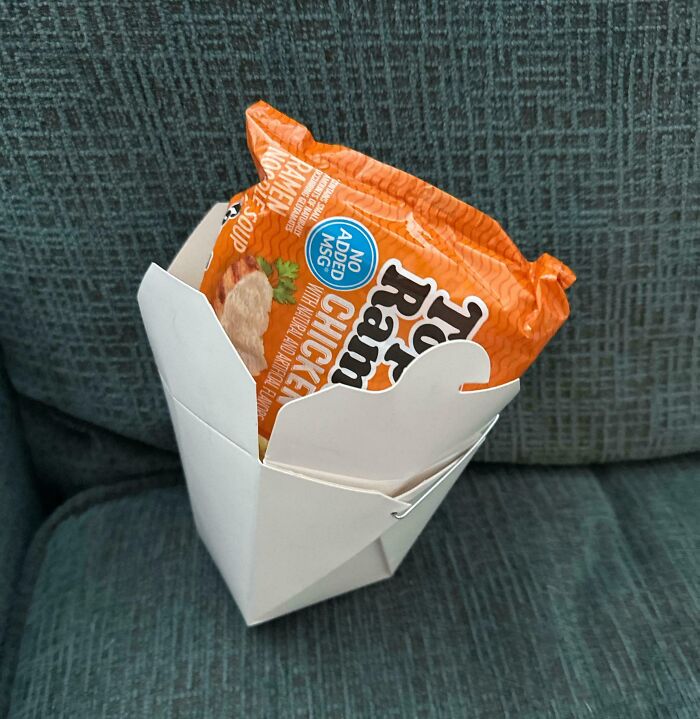 A pack of chicken ramen in a takeout box, symbolizing infuriating company gifts and bonuses.