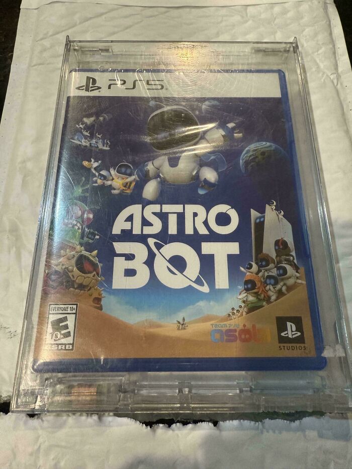 PS5 game case for "Astro Bot" inside misleading oversized protective packaging, representing online shopping scams.