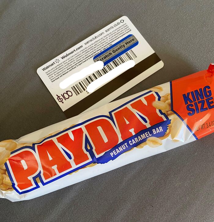 Payday candy bar next to a gift card, illustrating infuriating company gifts and bonuses.