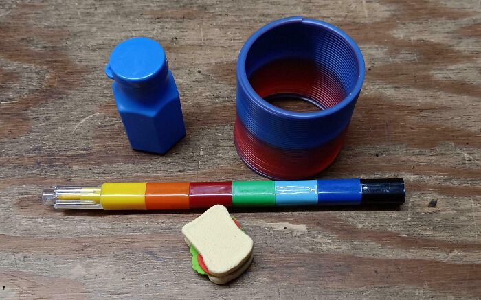 Assorted small toys on a wooden surface, showcasing infuriating company gifts.