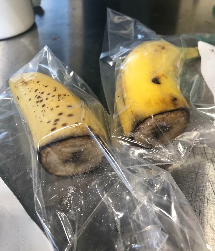 Two halved bananas in plastic bags, representing company gifts and bonuses.