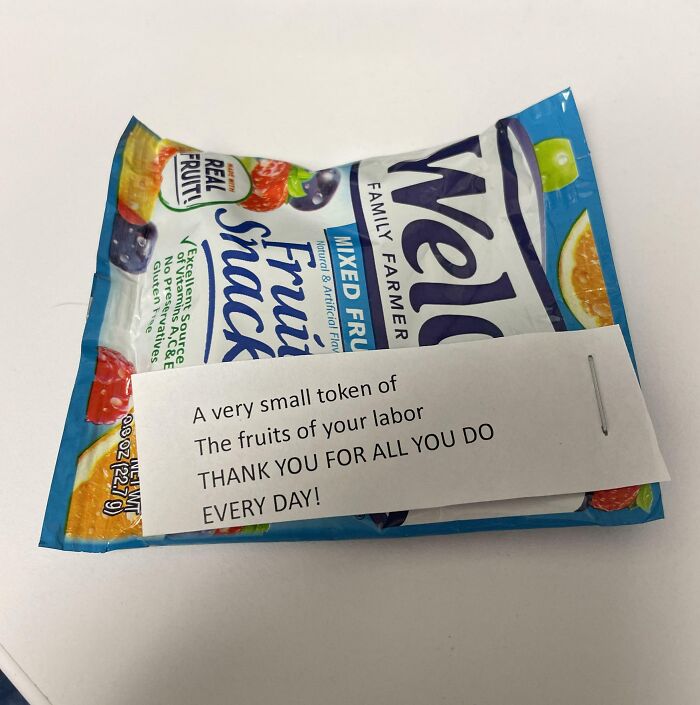 Fruit snacks with sarcastic note, symbolizing infuriating company gifts as bonuses.