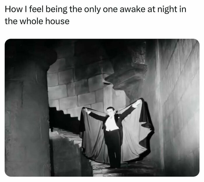 Black and white image of a person dressed like a vampire standing alone on stone stairs, humorously capturing burnout.