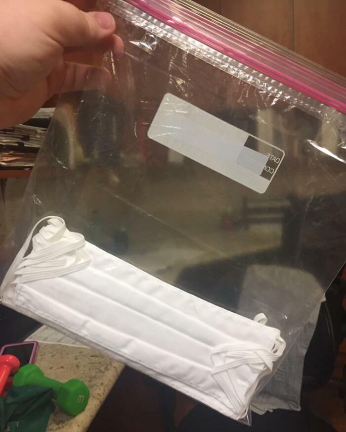 A large clear bag containing a white face mask, reflecting on infuriating company gifts.