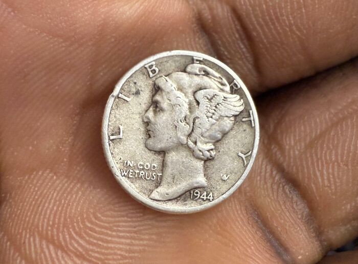 Rare 1944 coin featuring Liberty, held in hand, a treasure for numismatists.