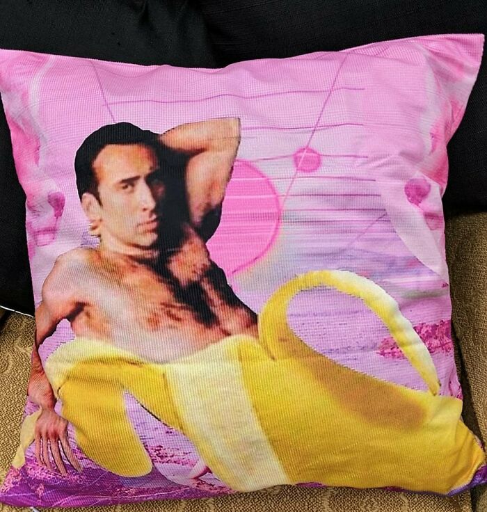Weird secondhand find: a pillow with a shirtless actor and a large banana on a pink background.