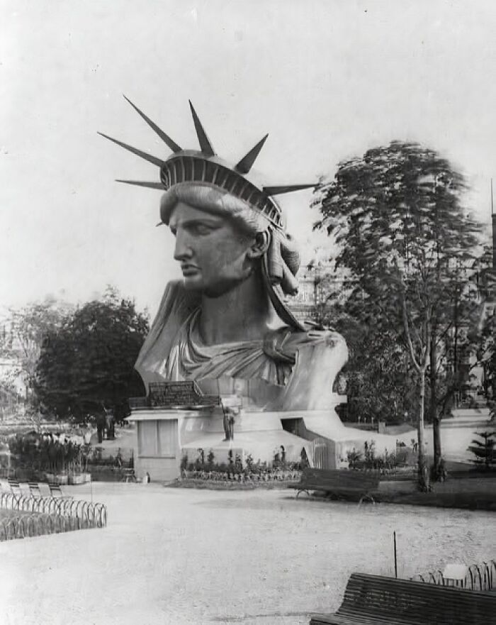 Statue of Liberty head in a park, showcasing random fascinating historical construction facts.