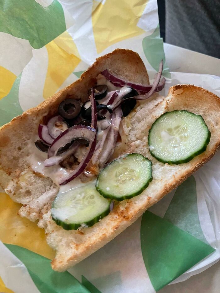 A disappointing sandwich with sparse toppings, showcasing classic food scams.