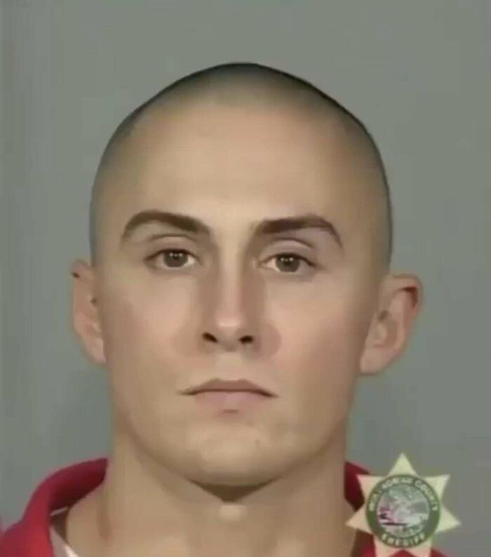 A man with a severely receding hairline and an unfortunate haircut, looking straight ahead in a mugshot.