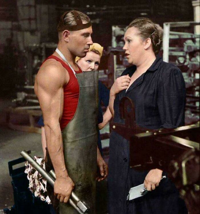 Workers in a factory setting, captured in an accidental renaissance style, conversing with intense expressions.