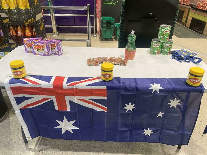 Australian-themed display with Vegemite, Milo, and flag at a store counter.