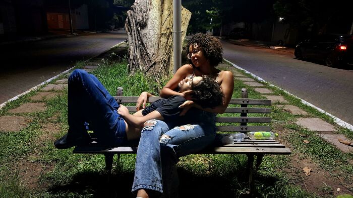 A couple on a bench at night, resembling an accidental renaissance painting.