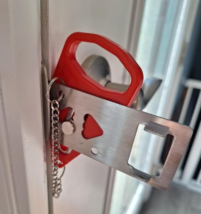 Portable door lock with a red handle, featuring chain and metal plate, ideal 5-star item under $20 for added security.