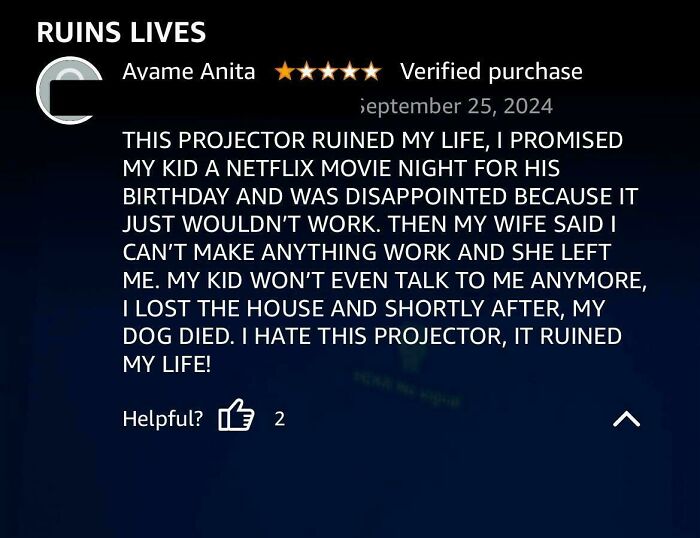 Funny review of a projector claiming it ruined the reviewer's life, rated 5 stars with a "Verified purchase" note.