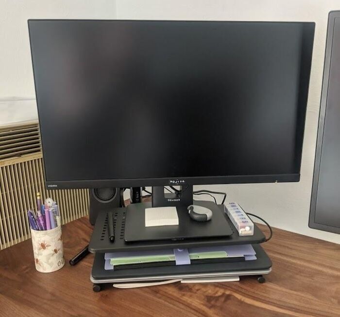 A monitor on a desktop with office supplies, under $20 items in use.