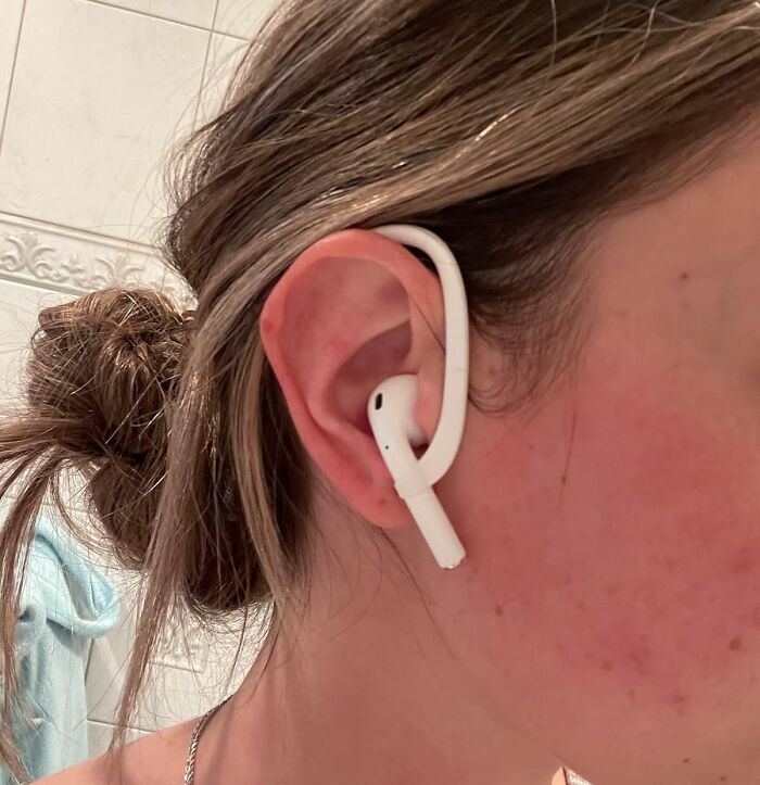 Earbud in ear, showcasing affordable 5-star items under $20 in a bathroom setting.