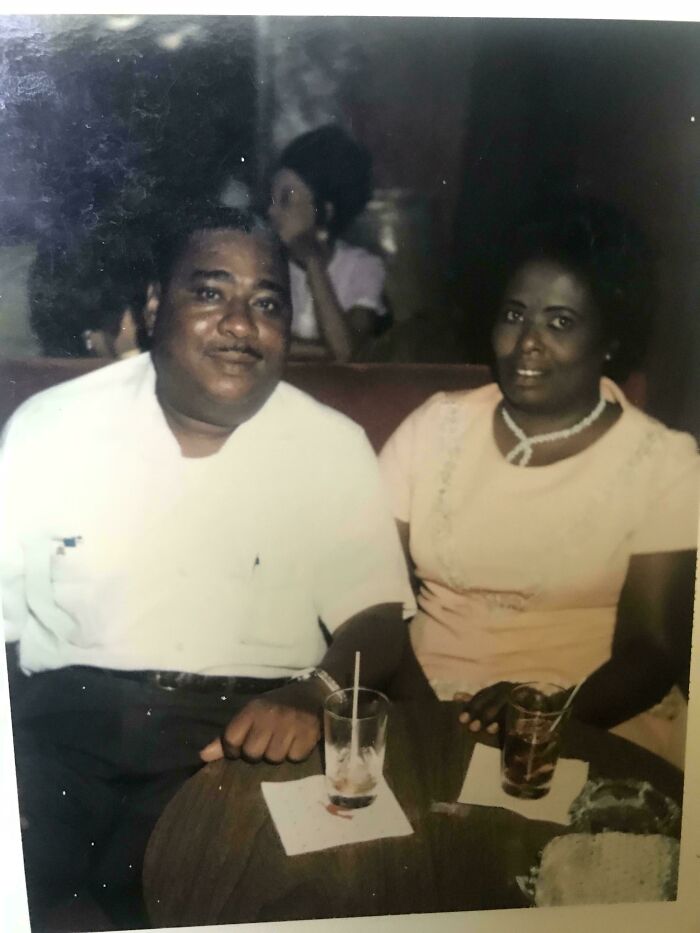 Vintage photo of a couple sitting closely at a table with drinks, captured in fascinating old images from history.