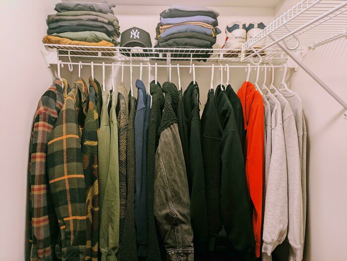 Neatly organized closet with jackets, folded clothes, and shoes, showcasing next-level organization.