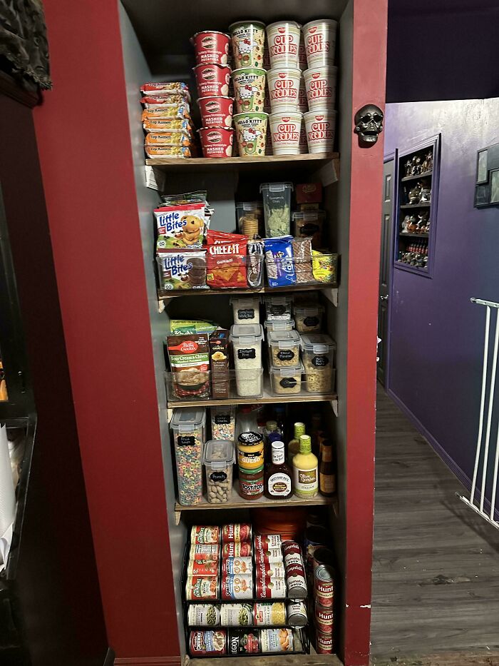 Neatly organized pantry shelves with canned goods, snacks, and kitchen essentials.