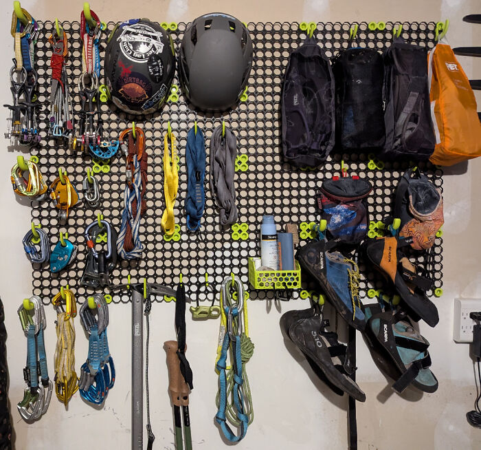 Neatly organized climbing gear on a pegboard, showcasing next-level organization skills.