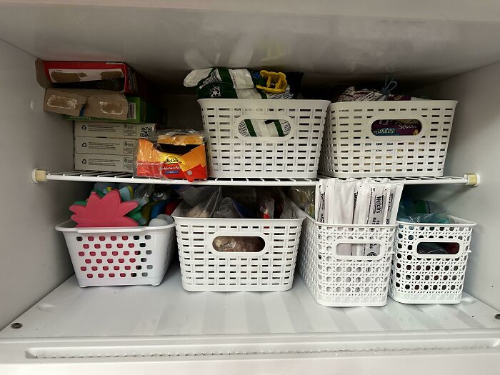 Neat organization of baskets in a freezer, showcasing next-level tidiness and storage efficiency.