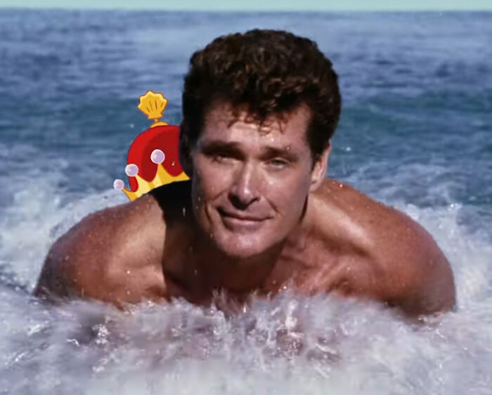 Man swimming in ocean with a cartoon crown edited behind him, highlighting questionable movie details for cinephiles online.