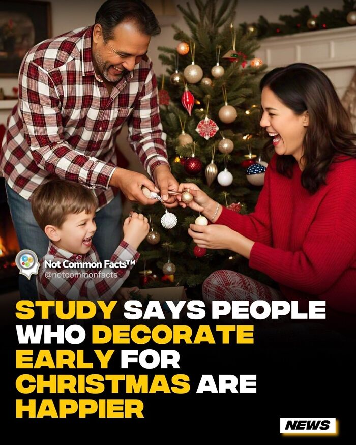 Family decorating a Christmas tree together, smiling and joyful during the holiday season.