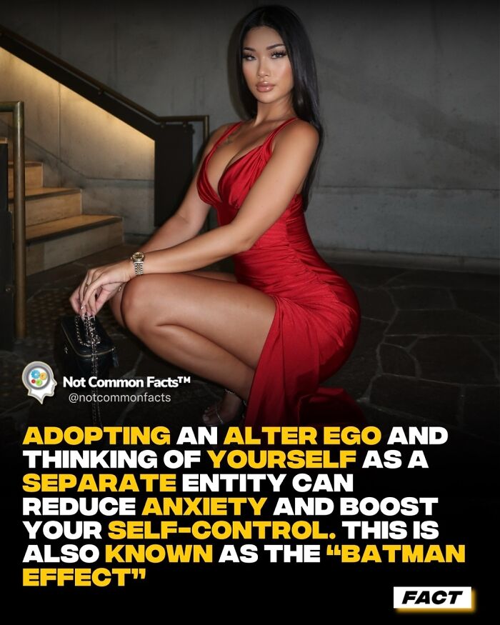 Woman in a red dress posing on stairs; text explains adopting an alter ego can reduce anxiety, known as the "Batman effect."